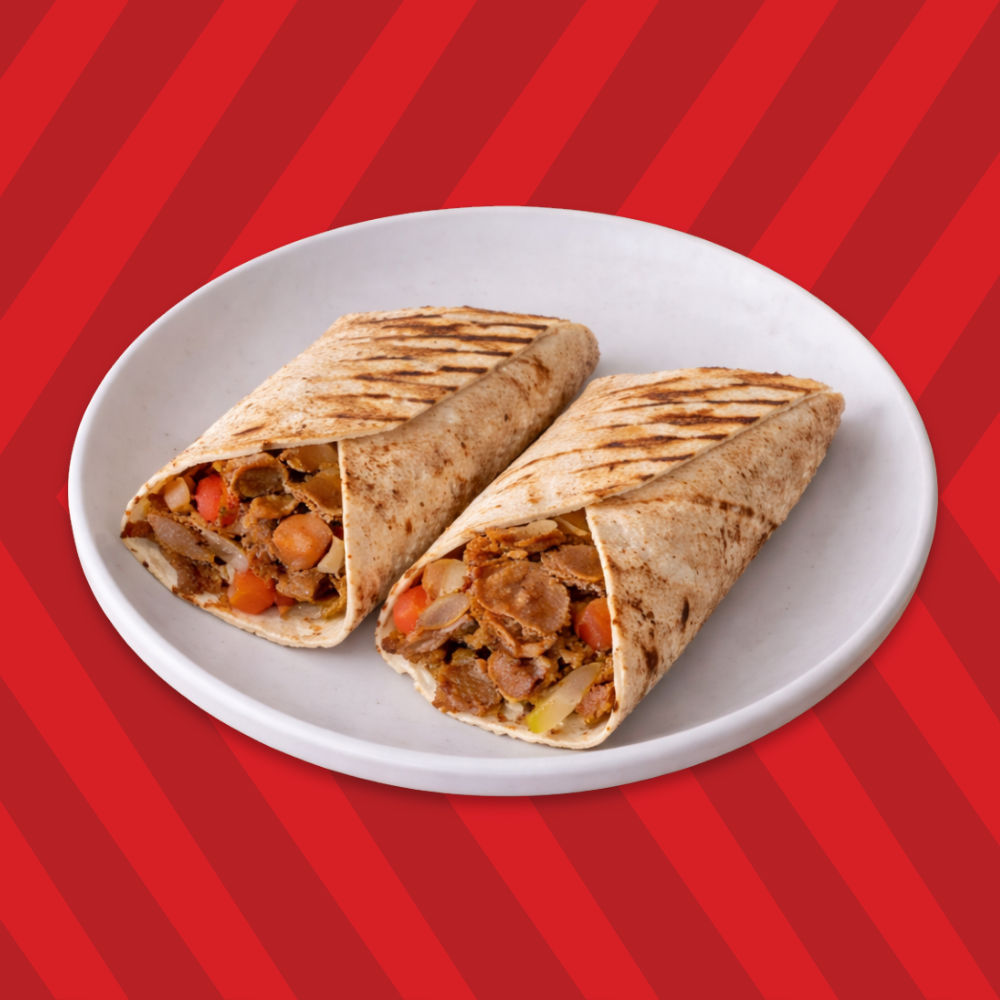 Donair wrap cut in half filled with seasoned meat and toppings